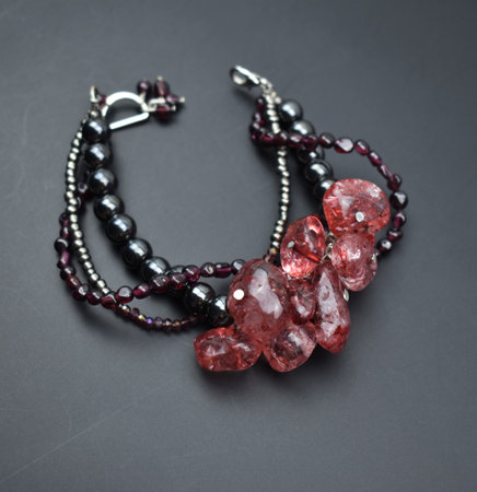 Bracelet made of red quartz and black beads on a black backgroundの写真素材