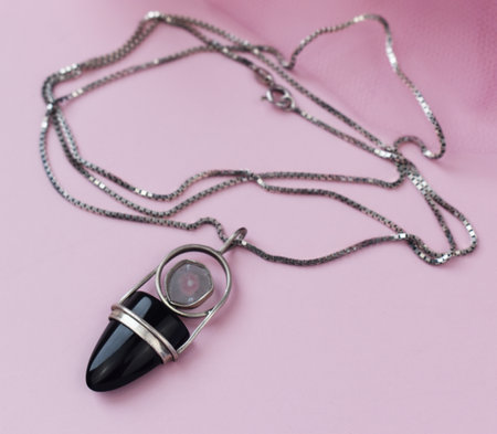 Necklace on a pink background. Jewelry for women.の写真素材