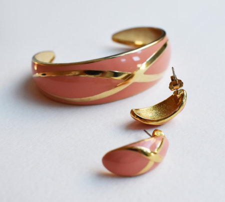 Pair of gold earrings on white background, closeup.の写真素材