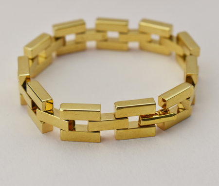 Bracelet made of gold bars on a white background close upの写真素材