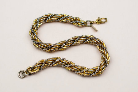 necklace made of golden wire on a light background close-up