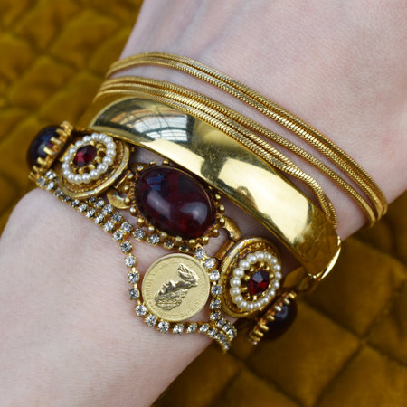 A closeup shot of a woman's hand with bracelets and jewelryの写真素材
