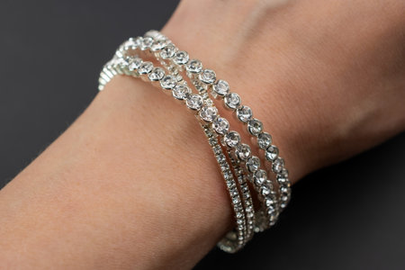 Diamond Bracelet on the woman's hand on a black background