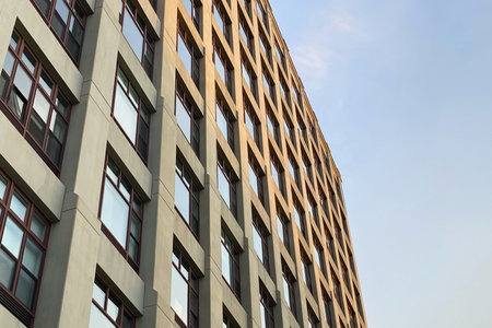Modern apartment buildings on a sunny day with a blue sky. Facade of a modern apartment building
