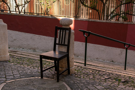 Lonely chair on the street in the old town of Lisbon, Portugalの写真素材