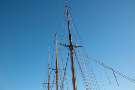 Masts and rigging of a sailing yacht against the blue sky.