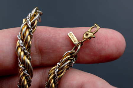 Bracelet made of gold and silver on the fingers of a man