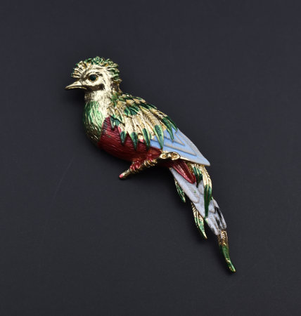 Metal figurine of a bird on a black background, close-upの写真素材