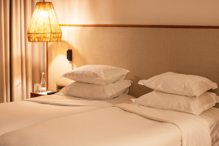 White pillows on bed and light lamp in hotel room. Interior designの写真素材