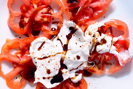 tomato salad with mozzarella and Balsamic Glaze on a white backgroundの写真素材