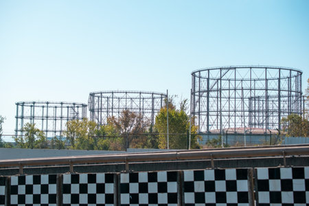 Railway station with black and white checkered flags against blue skyの写真素材