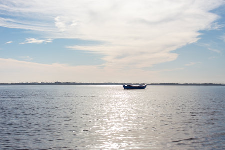 fishing boat on the lake with blue sky and white clouds.の写真素材