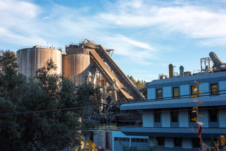Industrial landscape with silos and trees in a sunny day.の写真素材