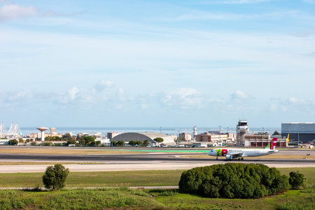 Airplane taxiing on runway of Lisbon airportのeditorial素材