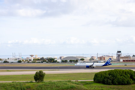 Airplane taxiing on the runway of Lisbon airportのeditorial素材