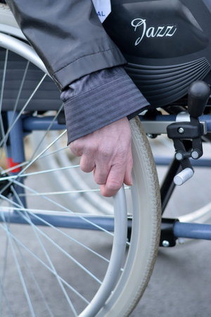 Hand on wheelchair wheel