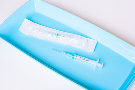 Two insulin or vaccine syringes on tray