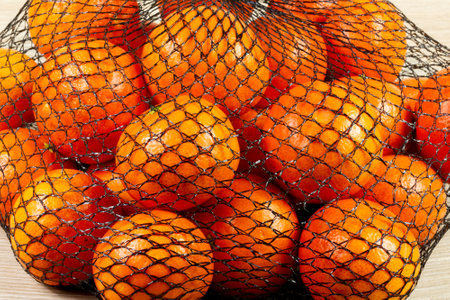 Clementines in a netの写真素材
