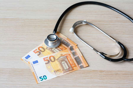Medical expenses, in Europe. 100 euros and stethoscopeの写真素材