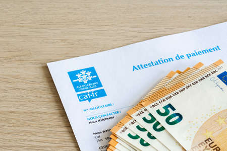 Certificate of payment from the Family allowance, in France, and banknotes in Eurosのeditorial素材