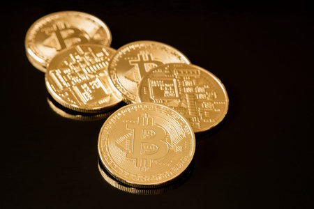 Bitcoins coins on black background