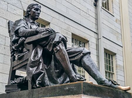 Cambridge, Massachusetts, USA, September 25, 2018. Harvard University, sculpture of John Harvard, in the center of Harvard Yard, the oldest area of the campus.のeditorial素材