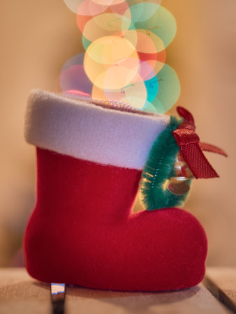 Christmas decoration with Santa's boot and bokeh lights on backgroundの写真素材