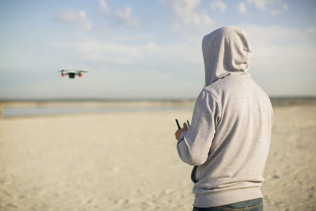 Man controls the drone in the beach