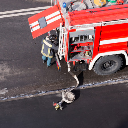 Red fire truck arrived on an emergency call. High angle view. Square image