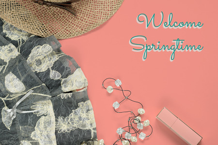 Flat lay feminine trendy fashion clothes and accessories collage, Welcome Springtime text on coral, top view. Spring conceptの写真素材
