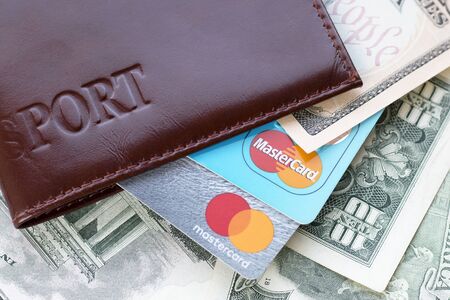 Passport, credit cards with Mastercard logo and US dollar banknotes. Moscow, Russia - May 2019. Identity of payment system, business, finance, banking, travelのeditorial素材