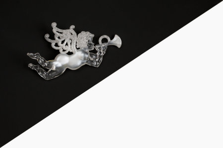 White Angel with horn flies through the night  sky. Musical christmas black and white background...