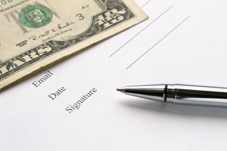 Signing a document. Blank document with place for signature, dollar banknote, ballpoint. Ballot, vote, donate, insurance themesの写真素材