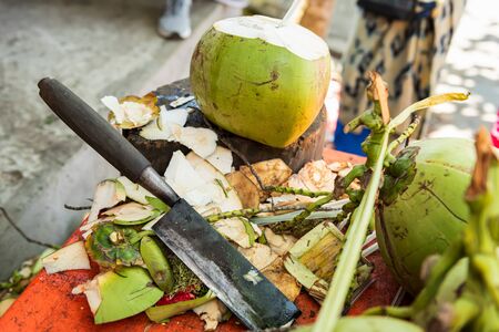 cut a top of coconut to sell refreshing coconut water to tourists. Bali, Indonesiaの写真素材