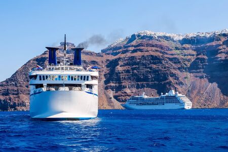 Ship sea trip. Santorini, Cyclades, Greece. Amazing Santorini view on white cave houses from the Aegean sea. Santorini, Cyclades, Greece.の写真素材