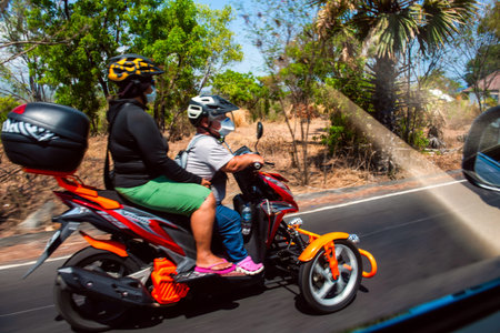 BALI, INDONESIA - November 30, 2019: Scooter Traffic on Bali. Indonesia