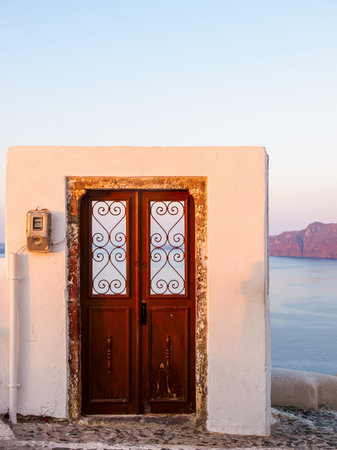Wooden Door to nowhere. Santorini island view. Cyclades, Greece.の写真素材