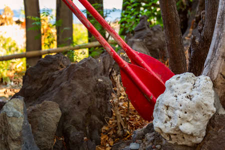 Two red oars as a detail of ancient boat as hotel outdoor decoration. Outside asian style interior. Bali, Indonesiaのeditorial素材