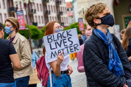 Wroclaw, Poland, 06.06.2020 - Young people hold a poster with words "Black lives matter" on polish peaceful protest against racism and hatred in Wroclaw city.のeditorial素材