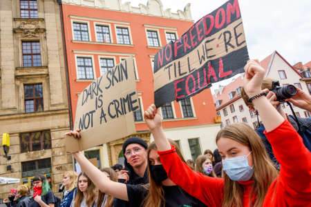 Wroclaw, Poland, 06.06.2020 - Young people hold a poster with words "no freedom till we`re equal" on polish peaceful protest against racism and hatred in Wroclaw city.のeditorial素材