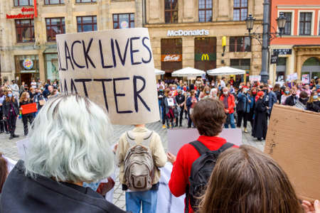 Wroclaw, Poland, 06.06.2020 - Young people hold a poster with words "Black lives matter" on polish peaceful protest against racism and hatred in Wroclaw city.のeditorial素材