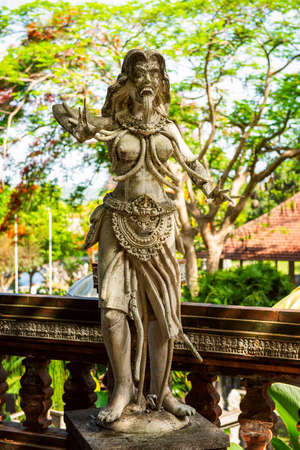 Calon Arang is a character in Javanese and Balinese folklore. Tradition calls her a witch, a master of black magic. Water Palace of Tirta Gangga in East Bali, Indonesia. Stone figure of balinese god. Stone statue from asian mythsのeditorial素材