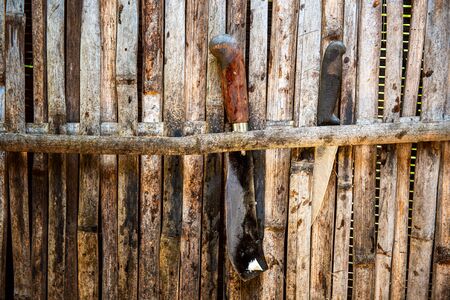 Vintage knives on a wall on balinese courtyard, rural scene. Bali, Indonesiaの写真素材