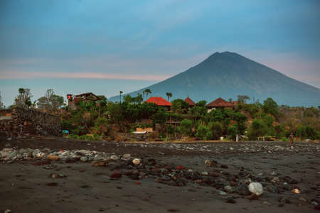 Amed village, slice life photo. Small local house, traditional balinese boat and chickens around. Black sand beach. Bali, Indonesiaのeditorial素材