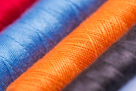 Close up photo of multicolor sewing threads