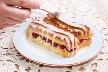 Eclairs with raspberries. delicious dessertの写真素材