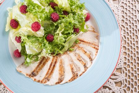 Delicious slices of grilled chicken and raspberry saladの写真素材