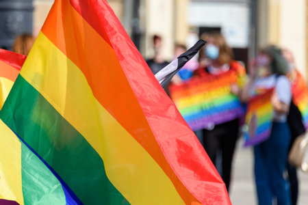 LGBT rainbow flag on foreground as a symbol of equality rights with blurred background. Equality...