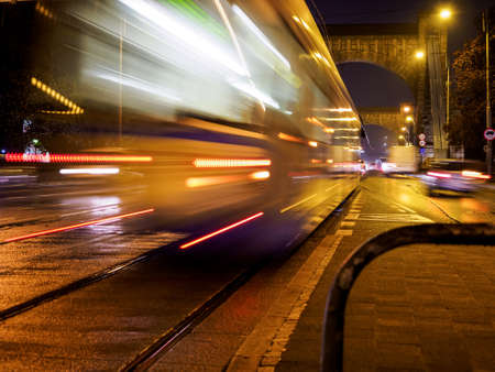 public transport driving at night city streetの写真素材