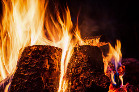 Night campfire with available space. Big bonfire against black background. Sparks of bonfire and...